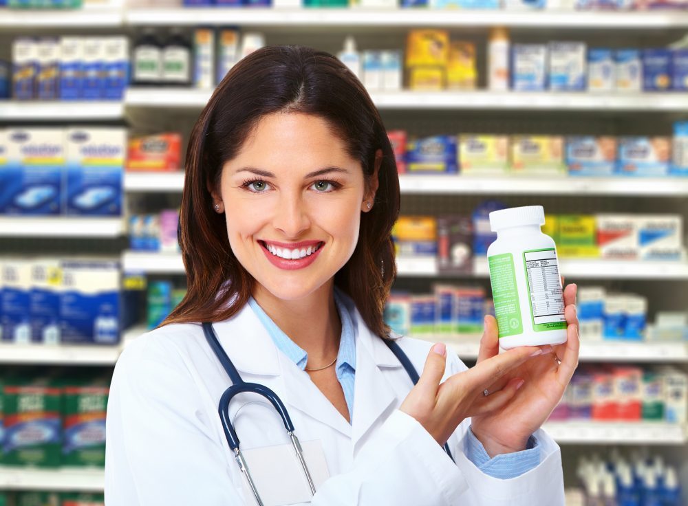Female Retail pharmacist with otc bottle in hand